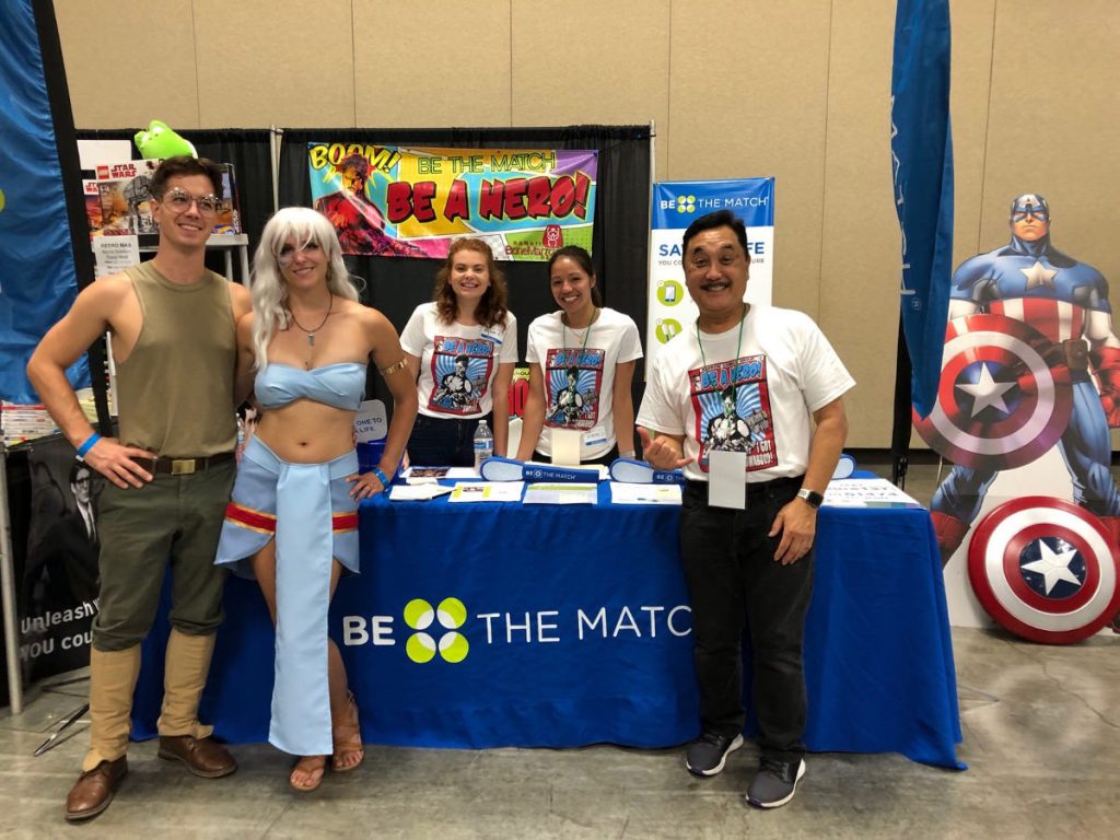 Logan and Erika in costume with Be The Match team at Comic Con